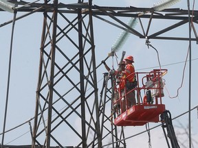 Technicians work at a hydro station near Lauzon Parkway and E.C. Row Expressway on Sept. 6, 2016, in Windsor, Ont. A massive outage occurred in Windsor and parts of Essex county.