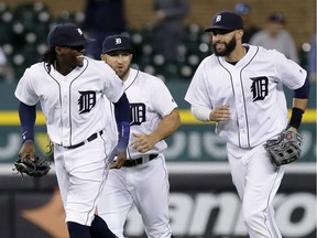 Cameron Maybin (4) of the Detroit Tigers celebrates with Tyler Collins (18) and J.D. Martinez (28) after a 4-2 win over the Minnesota Twins at Comerica Park on Sept. 12, 2016 in Detroit, Mich.