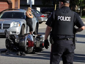 Police investigate a the scene of a motorcycle accident at Wyandotte Street and Langlois Avenue in Windsor on Monday, September 19, 2016. The driver of the motorcycle was transported to hospital.