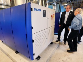 Mayor Drew Dilkens, left, and John Guidolin, manager of process engineering and maintenance at the Lou Romano Water Reclamation Plant, check out a newly installed turbo blower on Friday, Sept.16, 2016 at the plant.