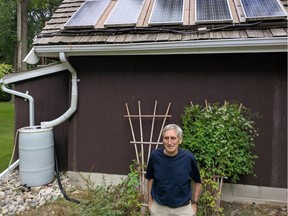 Joe LaFontaine, retired general manager of the LaSalle Hydro Electric System, stands in front of the solar array he built on his garage in LaSalle.
