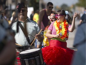 A woman dressed as a clown follows the Essex and Kent Scottish Regiment Pipes and Drums as they march downtown during Open Streets Windsor Sunday, September 18, 2016. This is the second Open Streets Windsor event, where a long stretch of road is closed to automobile traffic from Olde Sandwich to Ford City.