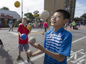 Andrew Tang, 11, and Mason Lapensee, 10, centre, both Grade 6 students from Dougall Public School, show off their juggling skills during Open Streets Windsor Sunday, September 18, 2016. This is the second Open Streets Windsor event, where a long stretch of road is closed to automobile traffic from Olde Sandwich to Ford City.