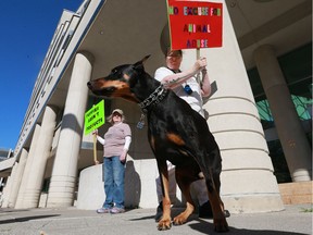 Sheila Anderson, left, and Heather Tremblay with her dog Zeke protest in front of the Provincial Court on Monday, Sept. 12, 2016.