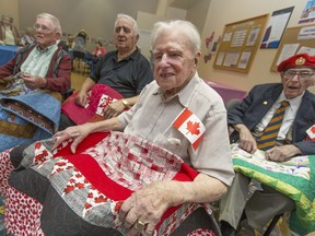 Jack Skelton, 101, front, is joined by, from back-left, Edgar Hoe, 93, Don Brancaccio, 92, and Jim Taylor, 89, all Second World War veterans who received quilts from Quilts for Valour, at Chartwell Oak Park Terrace Retirement Residence Thursday, September 1, 2016.