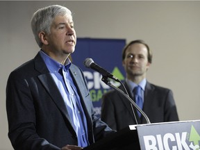 Gov. Rick Snyder announces his re-election bid this morning at the Jackson Group International headquarters Monday, Feb. 3, 2014 in Detroit. To his left is Lt. Gov. Brian Calley.