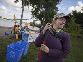 Gina Pannunzio, a remedial action plan assistant with Detroit River Canadian Cleanup, helps pick up garbage at McKee Park to mark World Rivers Day Saturday, September 24, 2016.