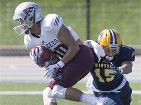 Windsor's Kaeden Walls makes the tackle on Ottawa's Marc-Elie Jace in the third quarter of OUA football action between the Windsor Lancers and the Ottawa Gee Gees at Alumni Field, Saturday, September 24, 2016.