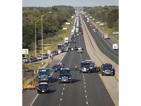 Several tow trucks were called in to clean up the scene of an eight-vehicle collision in the westbound lanes of Highway 401 at Dorchester Road, east of London, Ont. on Monday August 22, 2016. All three lanes of the highway were closed after a pickup truck, driven by a 21-year-old London man, collided with a car while merging into the fast lane for a construction lane reduction.  The crash set off a chain reaction, leaving debris scattered across the busy highway.  The driver of the car was extricated from his vehicle by emergency services.  Several other people were transported to hospital with non-life-threatening injuries.  Craig Glover/The London Free Press/Postmedia Network