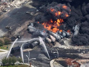 Smoke rises from railway cars that were carrying crude oil after derailing in Lac-Megantic, Que., on July 6, 2013.