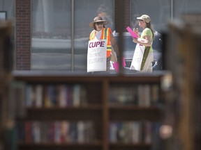 In this file photo, Essex County library workers walk the picket line outside the LaSalle library on the first day of a strike, Saturday, June 25, 2016.