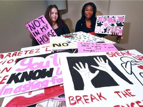 Naomi Levitz, left, and Trishauna Linton from Windsor Women Working with Immigrant Women, display signs destined for the Take Back the Night march on Saturday, Sept. 24.