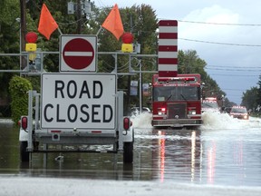 Tecumseh Fire trucks respond to a call on Lacasse Boulevard near Riverside Drive in   Tecumseh on Thursday, Sept. 29, 2016. Heavy rains caused flooding in much of the area.
