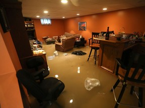 Joe Furlan surveys the flooding damage at his home on Lacasse Blvd in Tecumseh, Ontario on September 29, 2016.   Heavy flooding has hit SW Ontario.