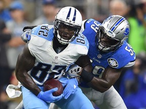 Delanie Walker #82 of the Tennessee Titans is brought down by Tahir Whitehead #59 of the Detroit Lions at Ford Field on September 18, 2016 in Detroit, Michigan.