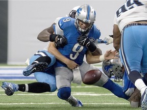 Matthew Stafford #9 of the Detroit Lions is sacked by Brian Orakpo #98 of the Tennessee Titans at Ford Field on September 18, 2016 in Detroit, Michigan. The Titans defeated the Lions 16-15