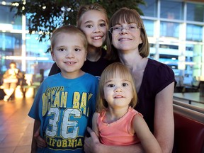 Sonya Kolar is shown with her children Christopher Renaud, 10, Connor Renaud, 6, and Alexa Renaud, 3, at the downtown bus station on Friday, Sept. 2, 2016. Kolar believes all children should be vaccinated.