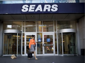 A shopper exits a Sears department store at the Toronto Eaton Centre in Toronto on June 20, 2013.