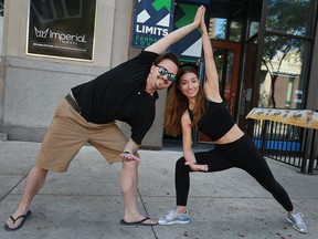 Higher Limits co-owner Jon Liedtke and yoga instructor Elyse Carvalho stretch outside the Ouellette Avenue lounge, which is hosting a marijuana-yoga event  Sunday as part of the Open Streets event.