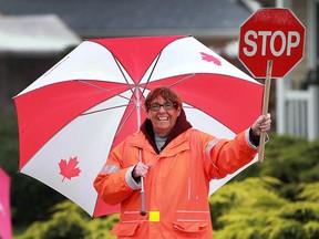 More rain didn't dampen Tecumseh crossing guard Claire Couvillion's spirit on Friday, Sept. 30, 2016.