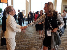 Premier Kathleen Wynne, left, talks with Sandra Pupatello during the Association of Municipalities Ontario annual conference at Caesars Windsor in Windsor on Aug. 15, 2016.