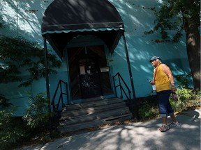 Sylvia Roughton walks past what remains of the Bridge Tavern in Windsor on Tuesday, September 13, 2016. City administrators are recommending the former watering hole be torn down.