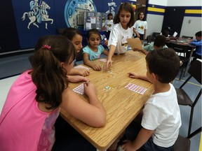 Volunteer Marsella Elishya (top right) leads a game of bingo for new Canadian students on a tour of Immaculate Conception School in Windsor on Friday, September 2, 2016.