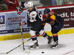 Windsor's Cristiano DiGiacinto passes the puck around Erie's T.J. Fergus at the WFCU Centre in Windsor on Thursday, September 22, 2016.