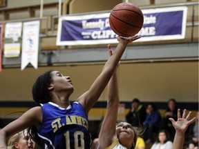 St. Anne's Cassandra Lesage, left, jumps for a rebound against Kennedy's Jana Khafur at Kennedy Collegiate in Windsor on Tuesday, September 27, 2016.