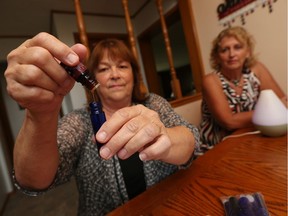 Shelley Roung (left) is joined by Janet Riley as she mixes up some essential oils at her home in Harrow on Wednesday, September 7, 2016.