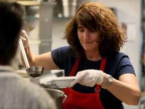 Linda Amato of the Rotary Club of LaSalle Centennial serves soup at the Downtown Mission, February 23, 2016. She is one of five volunteers being recognized by LaSalle.