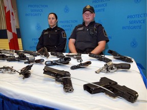 Canadian Border Services Agency officers display handguns on Thursday, Sept. 1, 2016 that were seized at land border ports of entry in Ontario. CBSA launched a Firearms Awareness Campaign asking American visitors to Canada to leave their firearms at home.