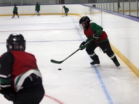 WMHA atom minor AA team practises at Adie Knox Arena, where LOOK UP warning lines have been painted on the ice surface for hockey players to be aware of danger zone around the boards, on Sept. 6, 2016.