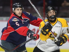 Windsor Spitfires Austin McEneny, left, checks Sarnia Sting Brady Hinz during the first period of OHL pre-season action from WFCU Centre on Sept. 9, 2016.