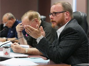 Coun. Chris Holt, right, discusses apartment-to-condominium conversions during a planning, heritage and economic development committee meeting at city Hall Monday September 12, 2016.