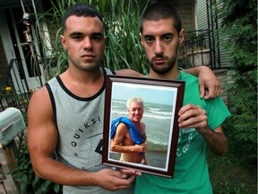 Lucas Brouillard, 26, left, and his brother Eric Brouillard, 24, hold a photograph of their father Yves Brouillard who died Sept. 9, 2016. Yves Brouillard was involved in a collision on Highway 3 on Sept. 1, 2016.