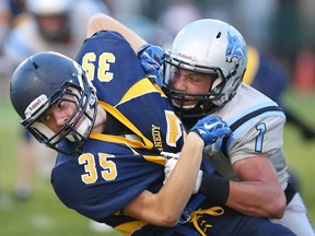 Kennedy Clippers Leif Erikson, left, gets tangled up with Villanova Wildcats Jacob Savoni during WECSSAA senior football action at Windsor Stadium on September 16, 2016 in Windsor, Ontario.
