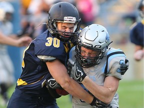 Kennedy Clipper  Robbie Reece, left, tackles Villanova Wildcat Zach Coste during WECSSAA senior football action at Windsor Stadium on September 16, 2016 in Windsor, Ontario.