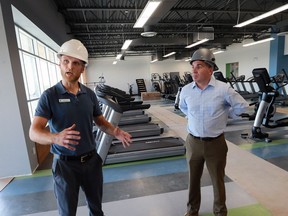 Andy Sullivan, left, general manager of the new Windsor YMCA and Andrew Lockie, YMCA of Western Ontario CEO give media a tour on Wednesday, September 7, 2016, in a fitness room.