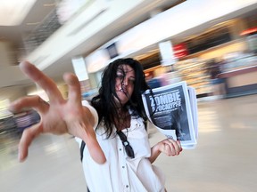 Political science student Esme Prowse with flyers for the zombie apocalypse conference, set to take place at the University of Windsor on Oct. 28 and 29.