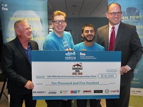 Mike Cooper (L) of Windsor's Bigg Wiggle Band presents a cheque for $10,500 to Lance Pratt, Mohamed Gharib, both from the Mayor's youth leadership team and Windsor Mayor Drew Dilkens on Wednesday, October 26, 2016, at Windsor City Hall. The money will be used for the 13th FINA World Swimming Championships.