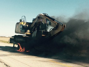 Leamington firefighters battled a heavy equipment fire Tuesday morning that forced the closure of County Road 37 near the intersection of County Road 8.