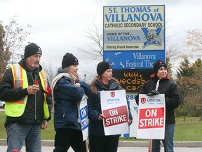 Striking support staff workers and UNIFOR Canada members picket outside Villanova Catholic Secondary School on October 27, 2016 in LaSalle, Ontario.