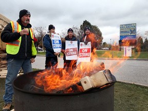 Striking support staff workers and UNIFOR Canada members picket outside Villanova Catholic Secondary School on October 27, 2016 in LaSalle, Ontario.