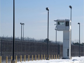 A guard tower stands over fencing at the Ionia Correctional Facility Monday, Feb. 3, 2014.  A national manhunt is underway for convicted killer Michael Elliot  who escaped from the prison on Sunday.