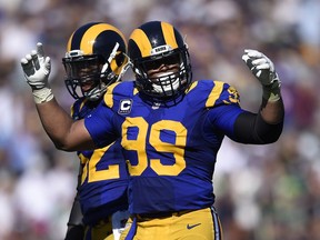 In this Sept. 18, 2016, file photo, Los Angeles Rams defensive tackle Aaron Donald tries to fire up the crowd against the Seattle Seahawks at Los Angeles Memorial Coliseum in Los Angeles.