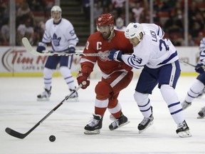 Detroit Red Wings left wing Henrik Zetterberg, left, and Toronto Maple Leafs center Brooks Laich chase the loose puck during the second period of an NHL preseason hockey game, Saturday, Oct. 8, 2016, in Detroit.