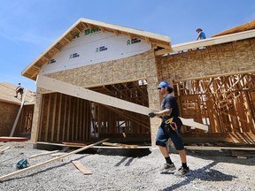 (file) Joel Parent, below, and his coworkers are shown at the construction site of a home in the 2200 block of Gatwick Avenue on Aug. 7, 2015, in Windsor.