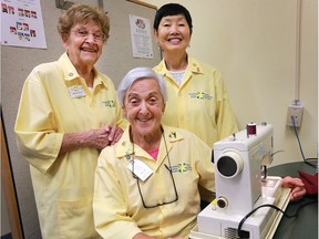 Canadian Cancer Society volunteers Mary Paterson, left, Maria Fogolin, centre, and Ann Kane have been donating their time to the organization for decades. They are shown during a break from sewing at the Windsor office on Tuesday, Oct. 18, 2016.