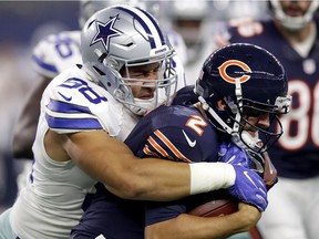 Tyrone Crawford #98 of the Dallas Cowboys tackles Brian Hoyer #2 of the Chicago Bears at AT&T Stadium on September 25, 2016 in Arlington, Texas.